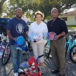 (L to R) Jeffrey Hatcher, Catherine Muth and Jackie Ford prepare for the donation of over 50 bikes and safety helmets to children for Christmas, 2021.