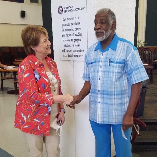 Catherine Muth and Henry Graham, Executive Director of LES, Inc.  Mr. Graham announced at the graduation ceremony on December 11, 2021 that the ORC Family Foundation will be continuing the work that he began in partnership with Sheridan Technical College to provide an Introduction to Construction at no cost to students.  LES, Inc. is discontinuing this program, but it will be continued under ORC Family Foundation and branded as Building Futures.  LES, Inc. is a non-profit that has served the community since 1961.  LES, Inc. continues to provide many other excellent programs that serve the area known as Liberia in Broward County.